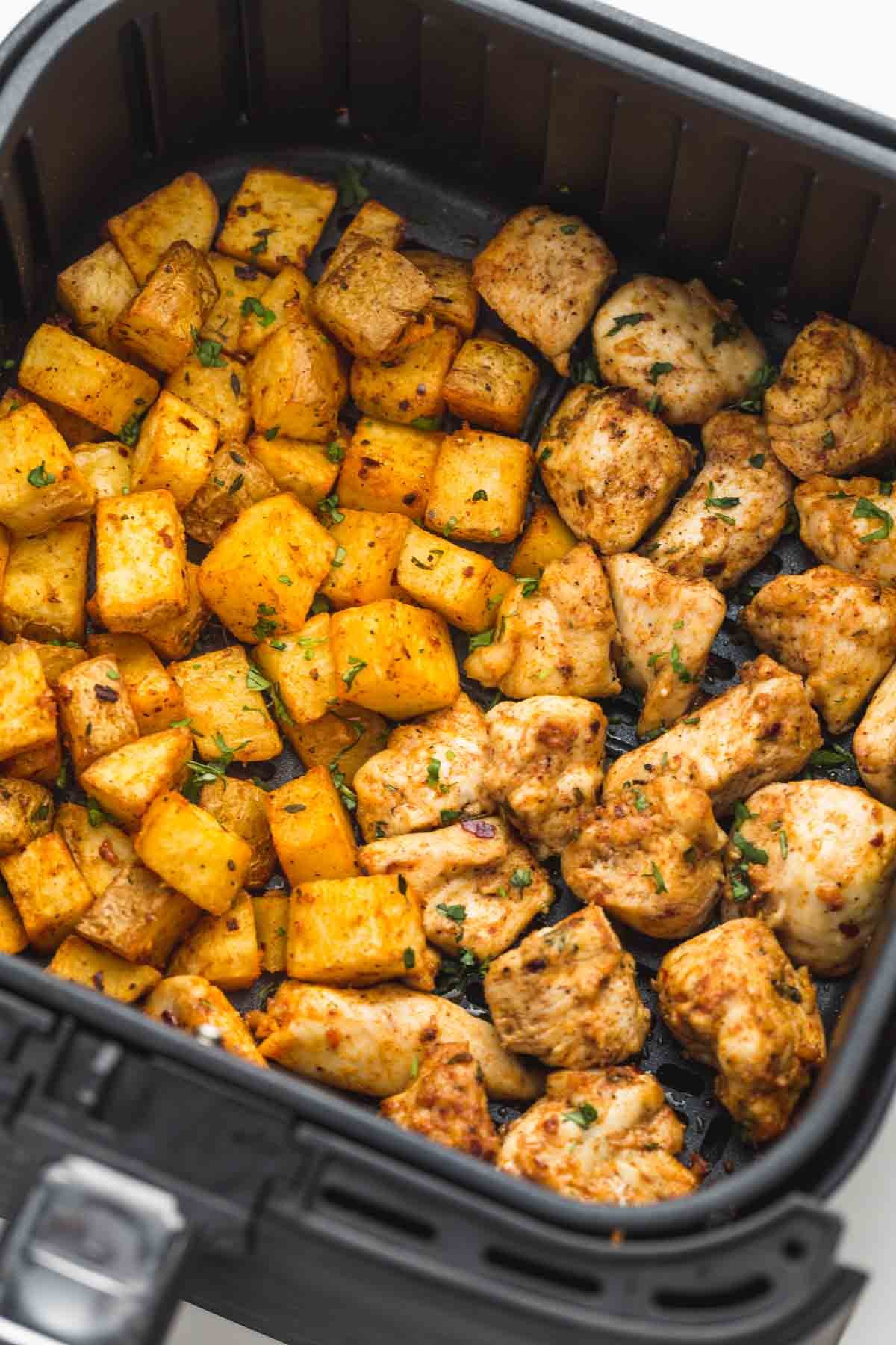 Chicken and potatoes are roasted in the air fryer
